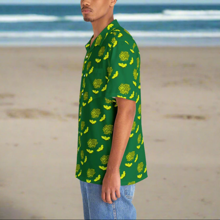 Man wearing a green shirt with yellow pattern on a beach background