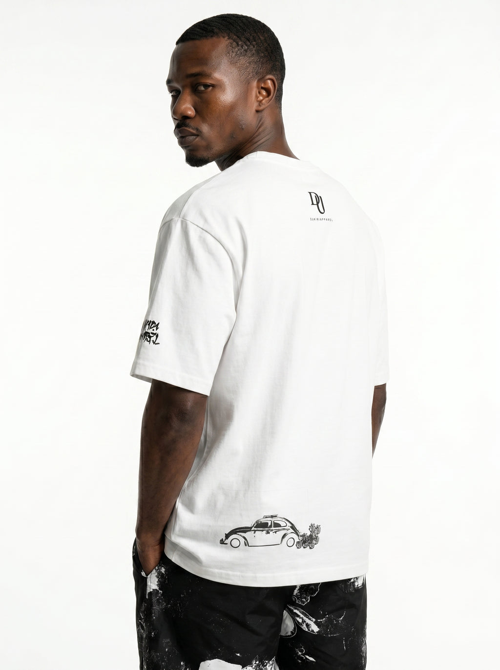 Man wearing a white t-shirt with black graphics on a white background
