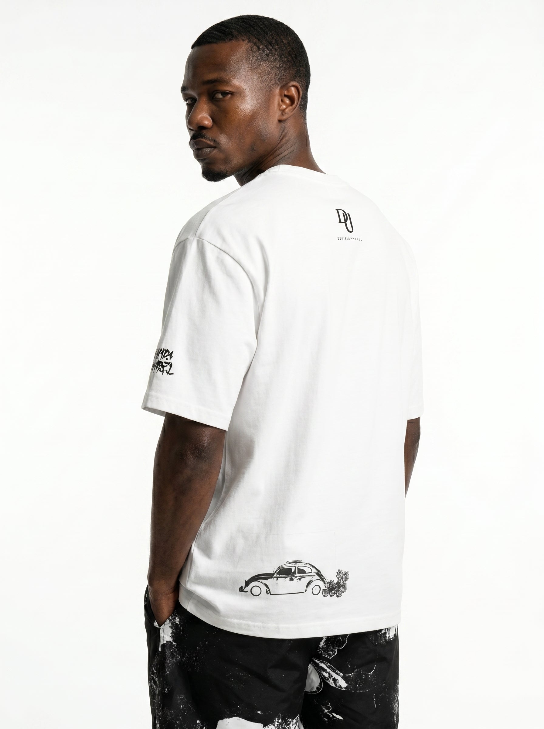 Man wearing a white t-shirt with black graphics on a white background