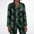 Black pajama set with green ghost pattern on a white background