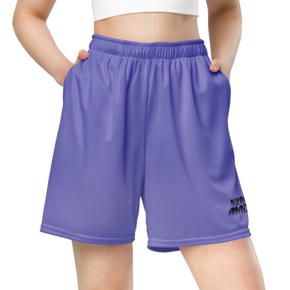 Female athlete in purple mesh shorts performing stretching exercise, showcasing the shorts' versatility and range of motion.