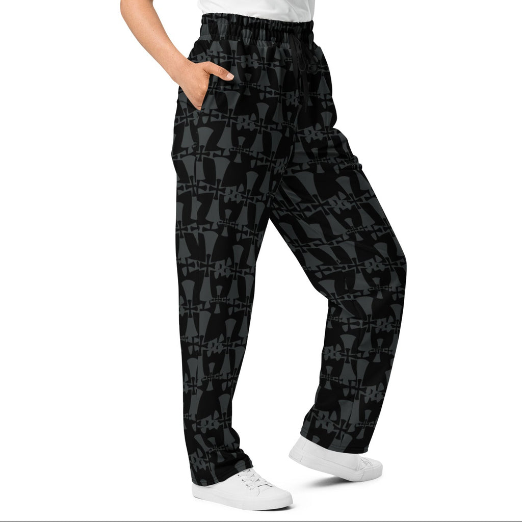 crusaders wide leg premium joggers in grey and back. Cross patterns all over print worn by woman.