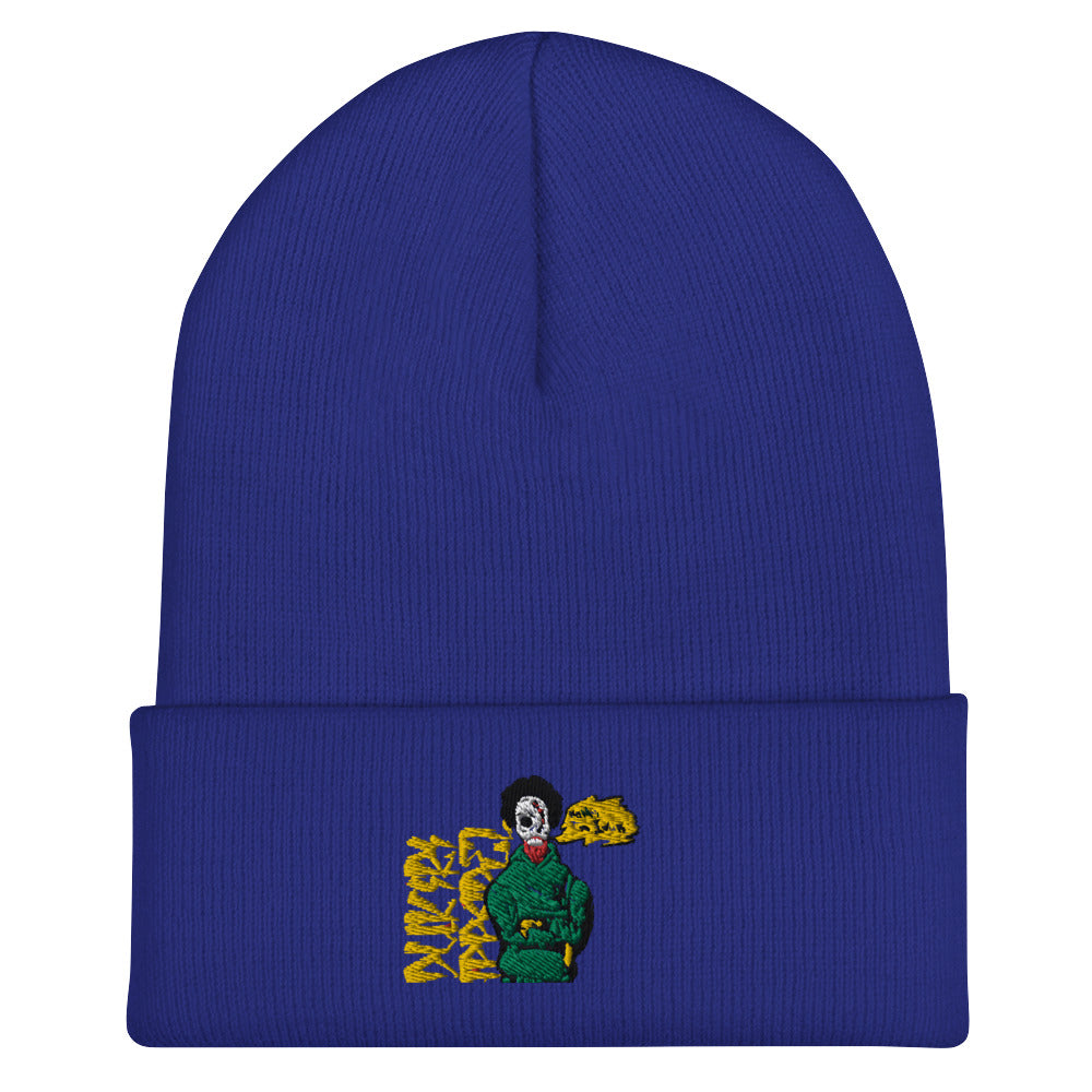 Royal blue beanie hat with embroidered graphic of a character in green, featuring artistic yellow text.