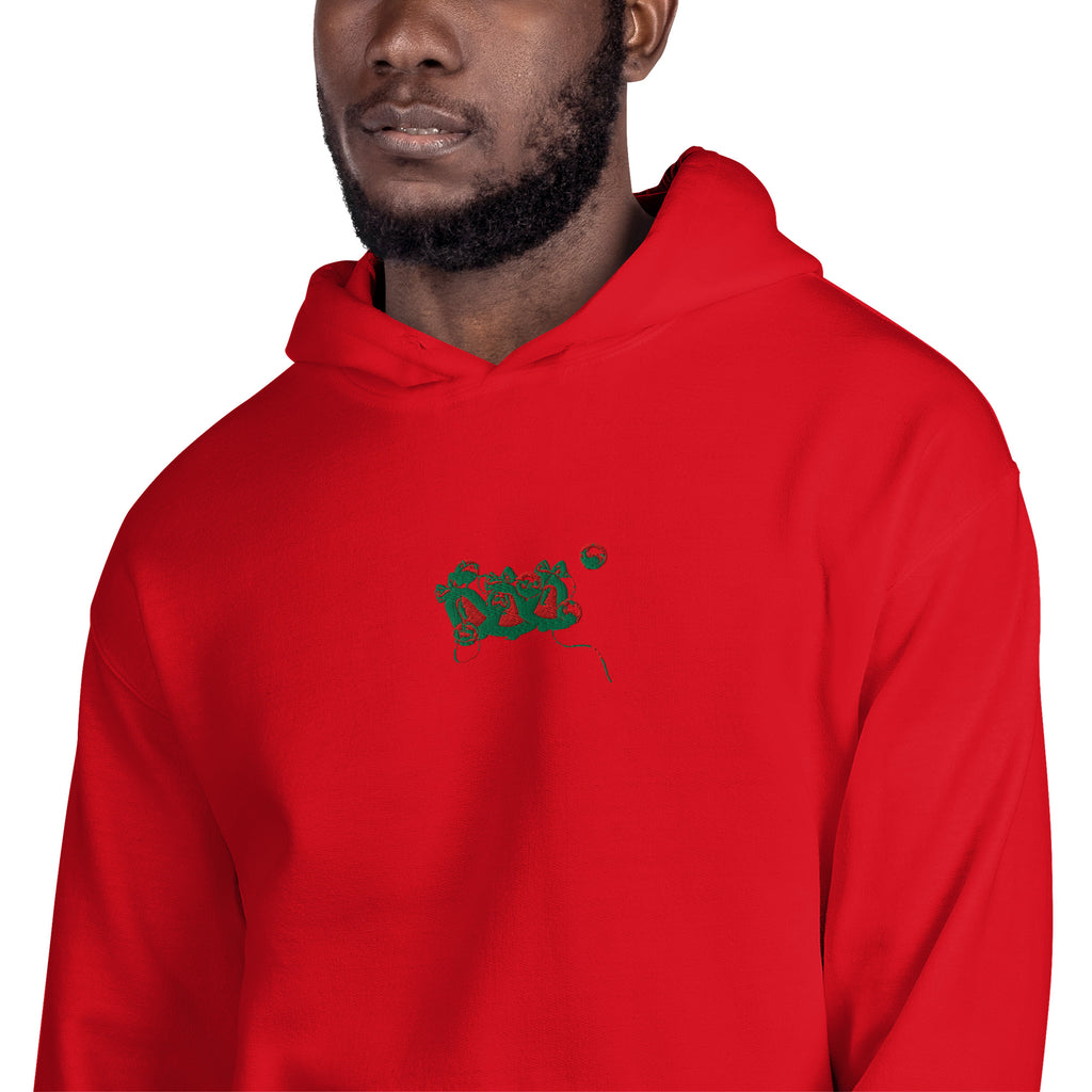 Black man wearing a christmas inspired  red hoodie with an embroidered jingle bell design from dukiri apparel