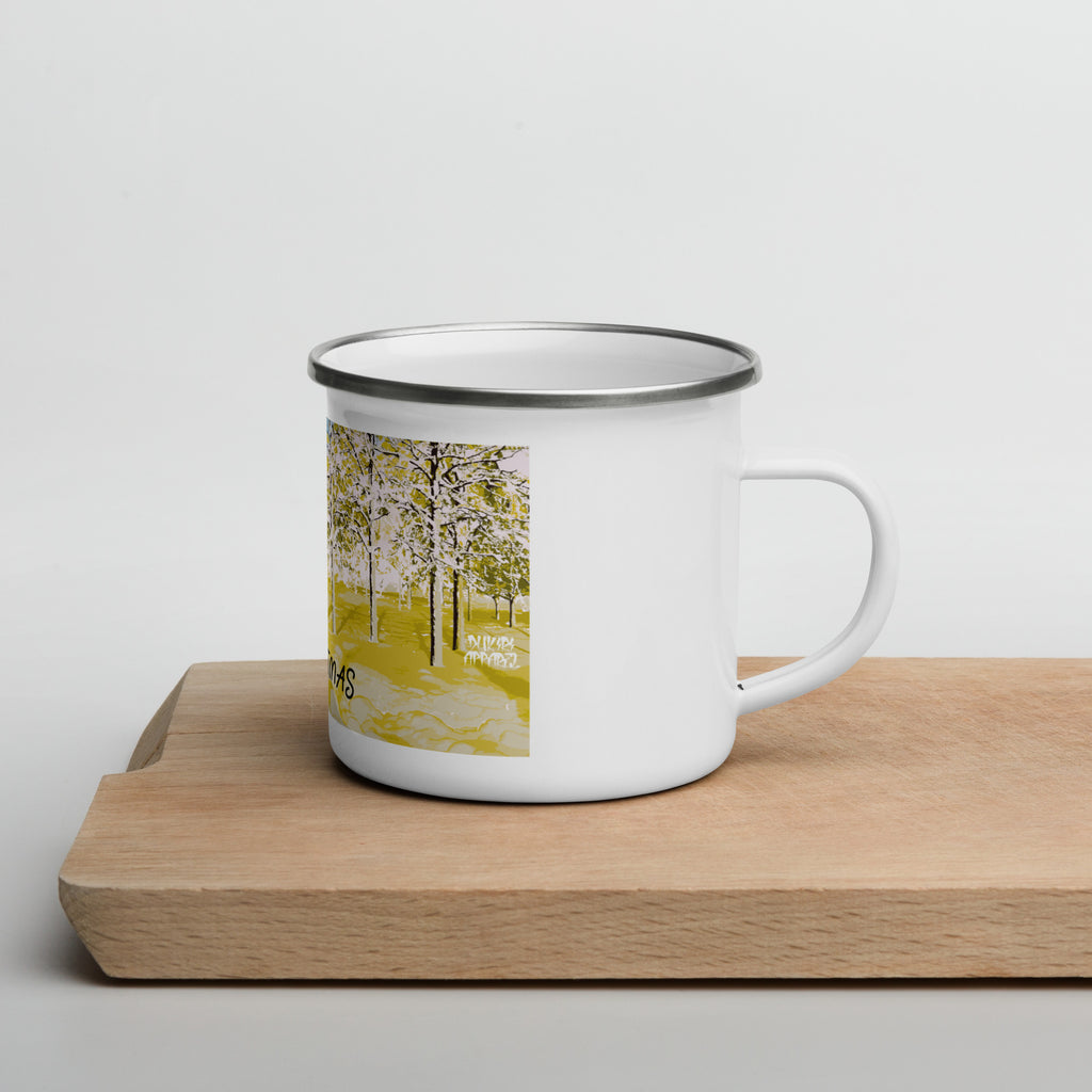 White enamel mug with a scenic design on a wooden surface