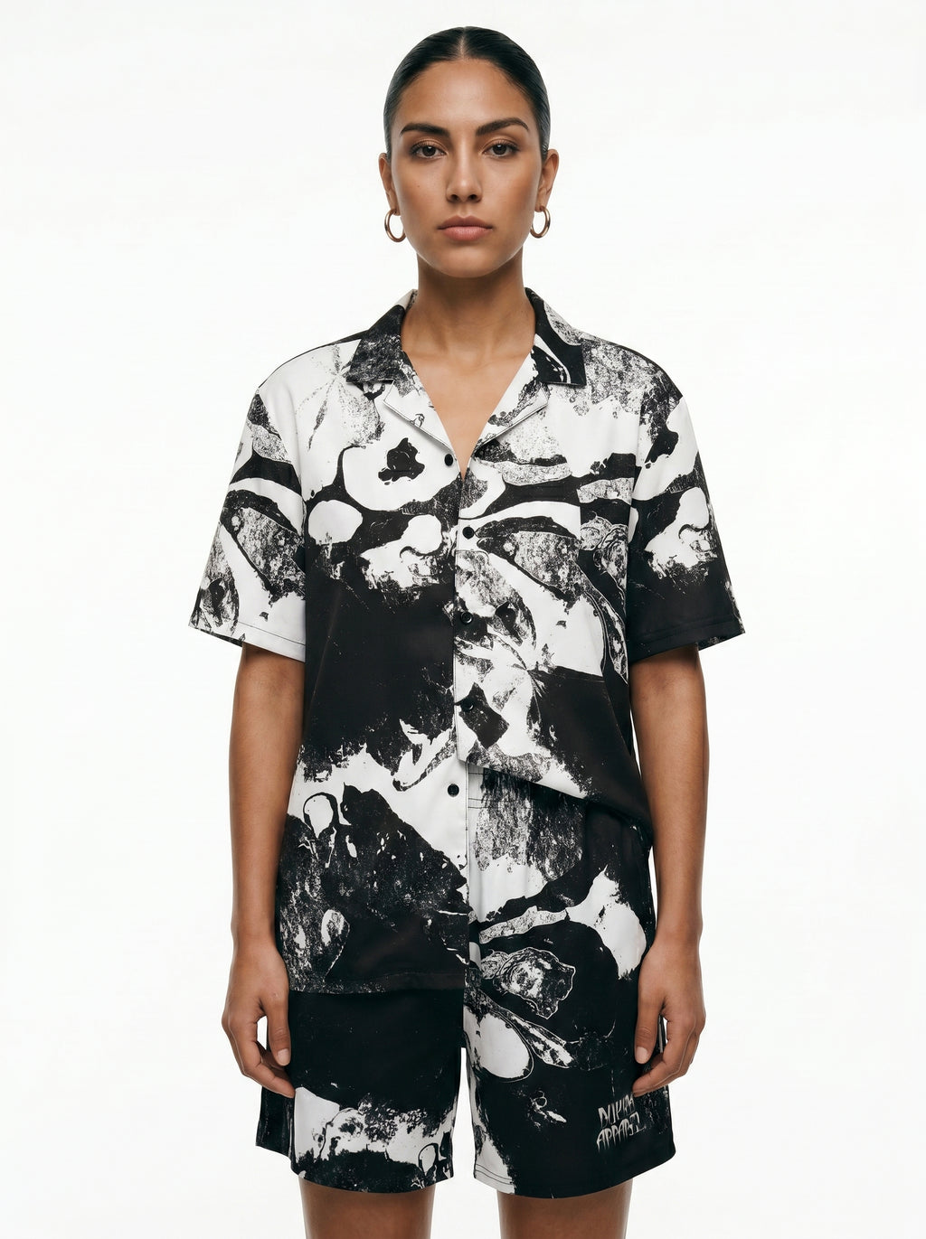 Person wearing a black and white patterned outfit on a white background
