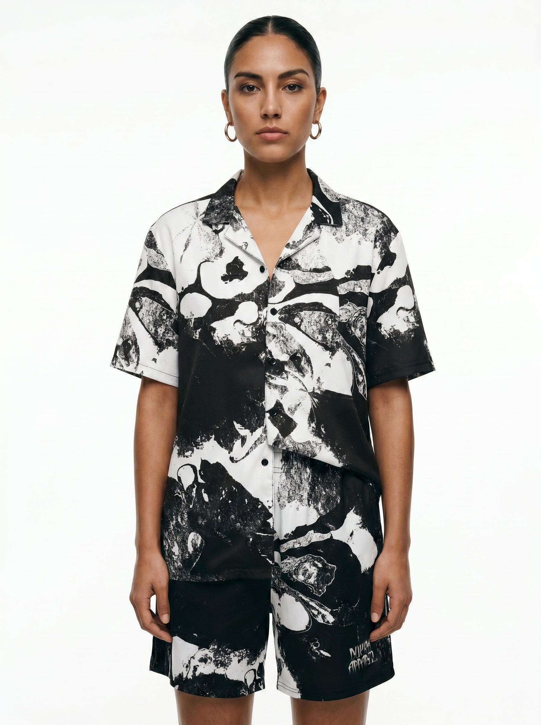 Person wearing a black and white patterned outfit on a white background