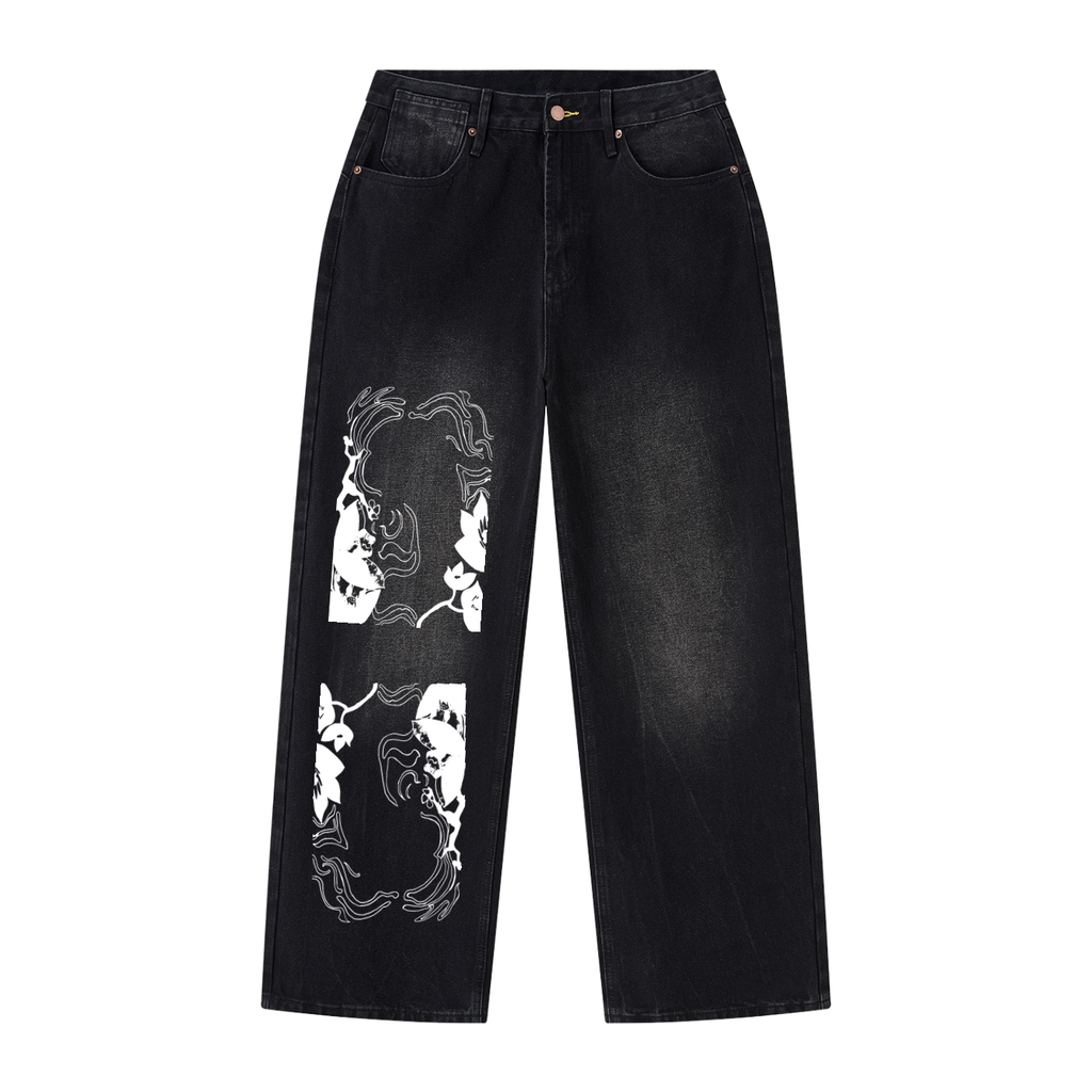 Black washed denim jeans with white graphic print panels on the left leg, displayed flat against a solid white background.