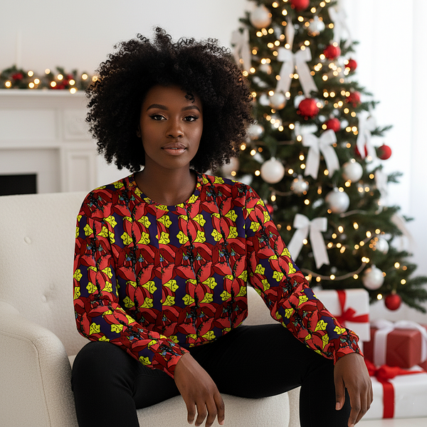Woman sitting on a couch wearing a colorful patterned shirt with a Christmas tree and presents in the background.