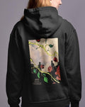 a woman wearing a black hoodie with a picture of flowers on it