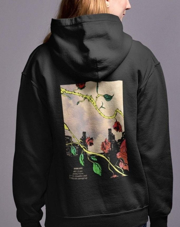 a woman wearing a black hoodie with a picture of flowers on it